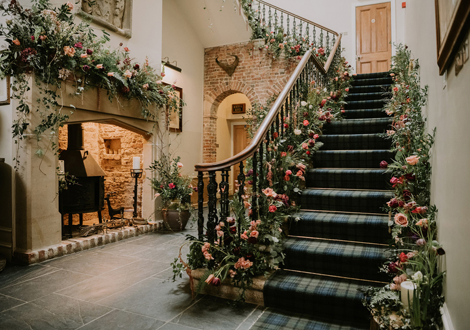 Floral decorated staircase with fireplace in Aberdeen Wedding Venue Logie Country House